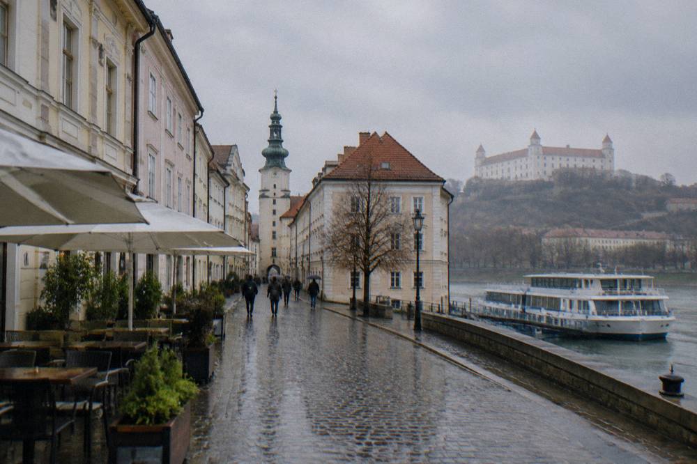 A Danube river cruise boat moored on the Bratislava waterfront near the Old Town