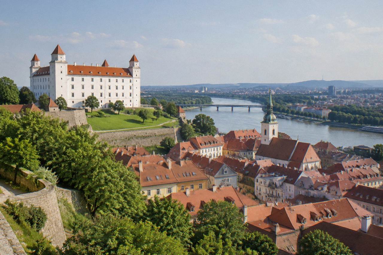 View over Bratislava Castle and the Old Town rooftops toward the Danube