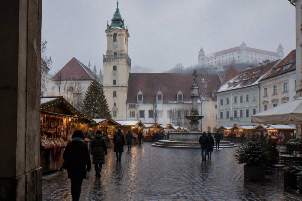 Christmas market stalls on a Bratislava square at dusk