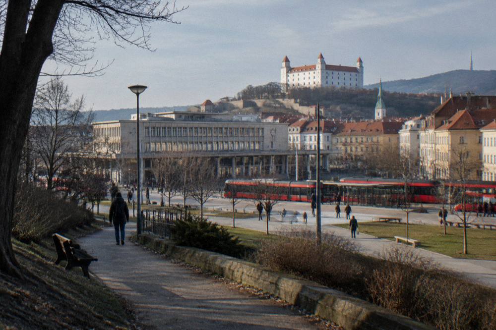 A hilltop castle building seen from a path on the edge of Bratislava
