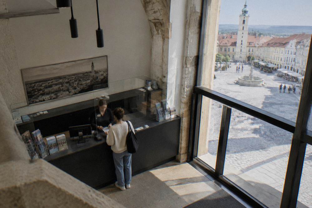 A museum ticket desk in Bratislava with a visitor paying