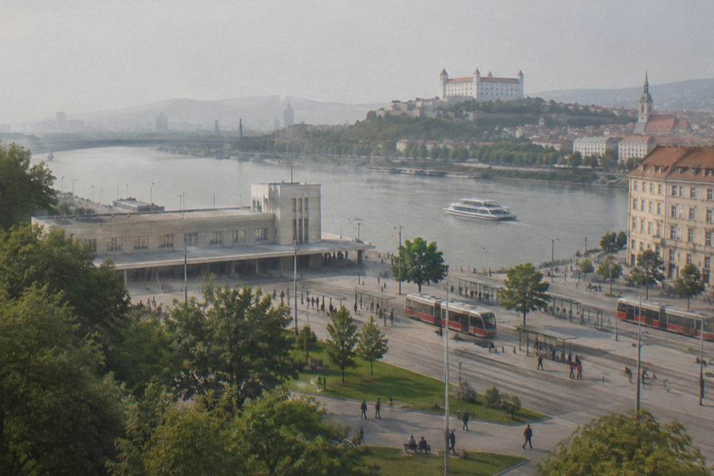 A passenger catamaran cruising along a wide river toward a city skyline