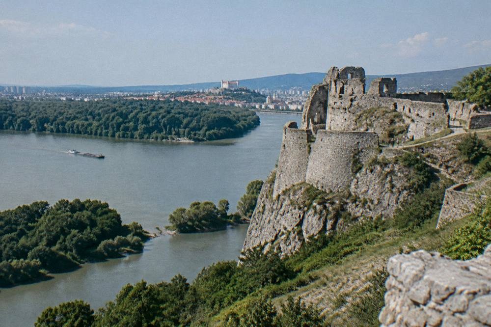 The ruins of Devin Castle above the confluence of two rivers on a sunny afternoon