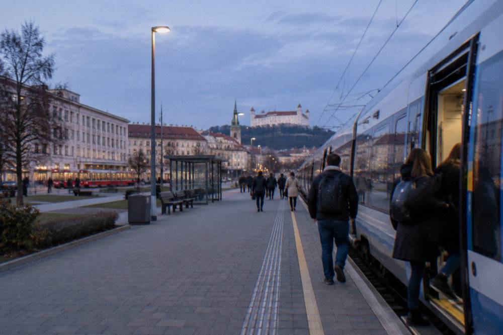 Passengers boarding a modern regional train at an Austrian railway station
