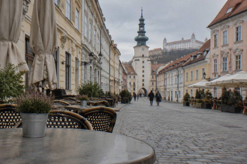 Café tables and coloured facades on a pedestrian square in Bratislava's Old Town