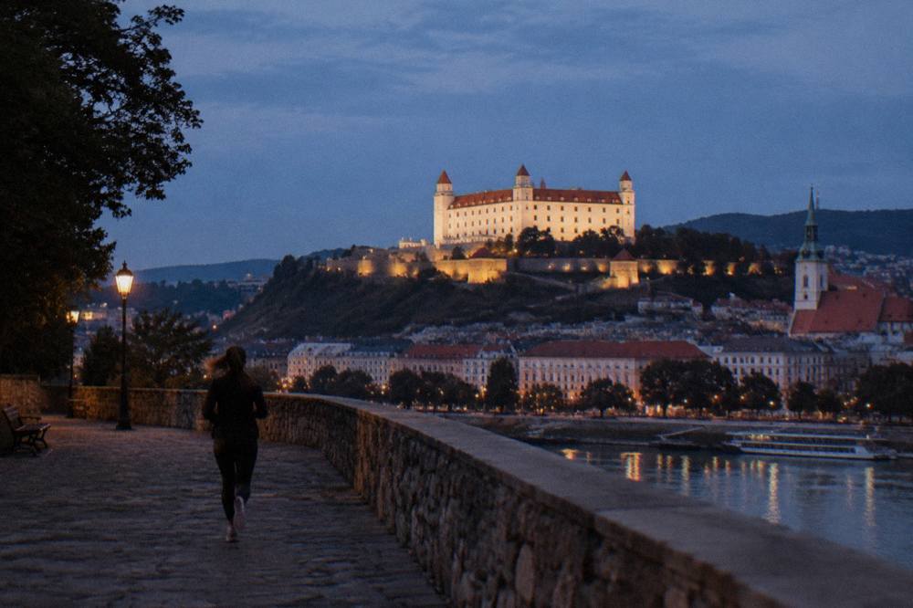 The floodlit Bratislava Castle on its hill above the city at night