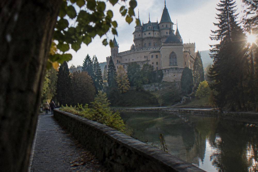 Bojnice Castle above its reflection pool, seen from the approach path