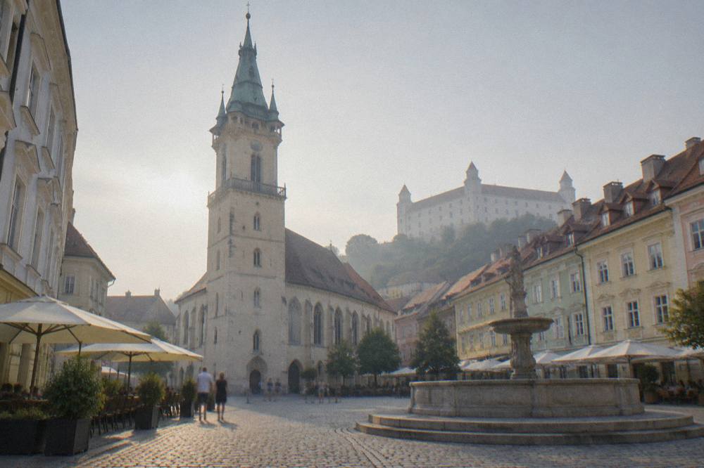Evening light on the Danube waterfront with the castle lit on the hill above
