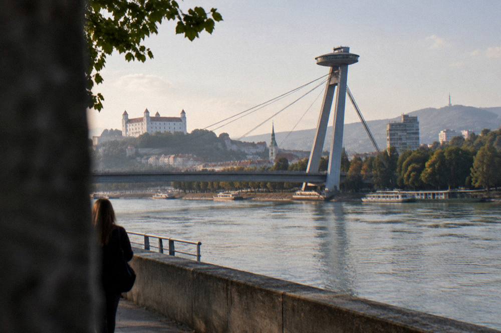 Evening light over the Danube riverfront with the UFO tower on the bridge