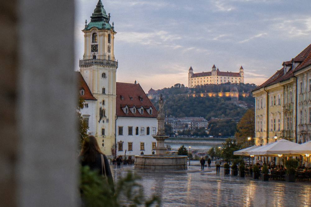 The Bratislava skyline at dusk with the castle lit above the Danube