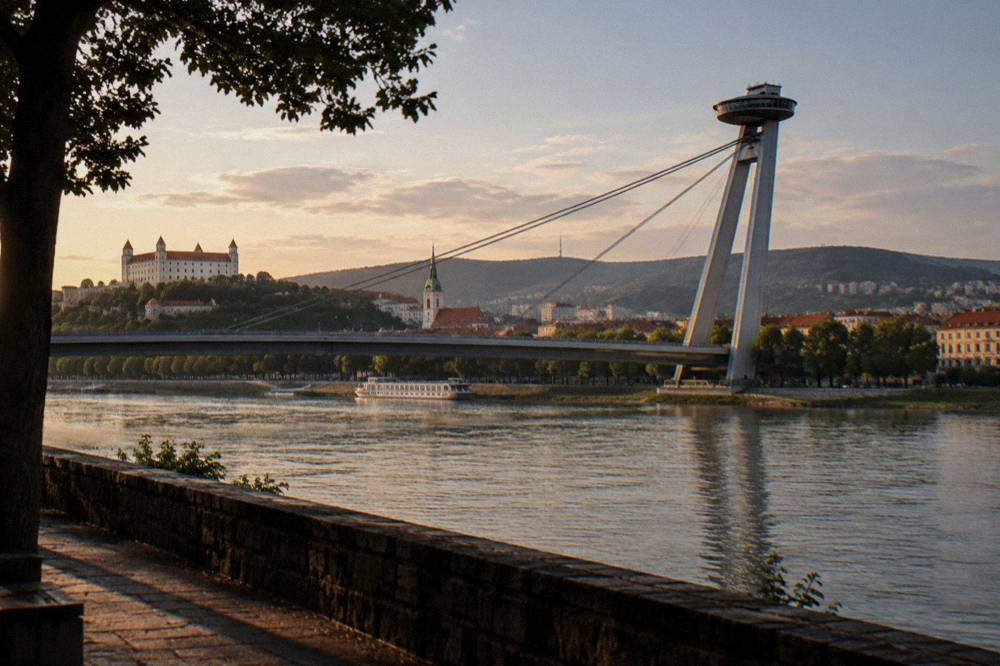 The UFO observation deck structure on a bridge pylon above the Danube at dusk