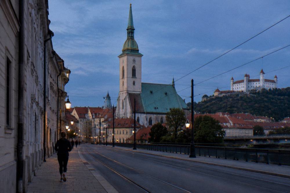 White towers and green roof of St Martin's Cathedral seen from a Bratislava street