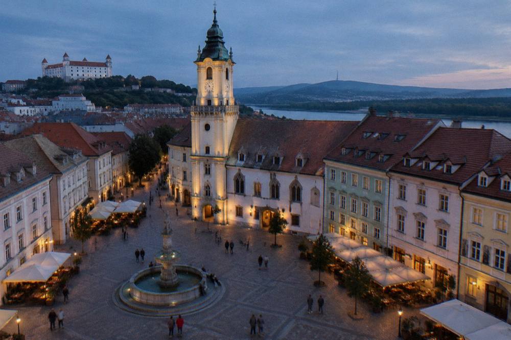 The Main Square in Bratislava at dusk with the old town hall lit up