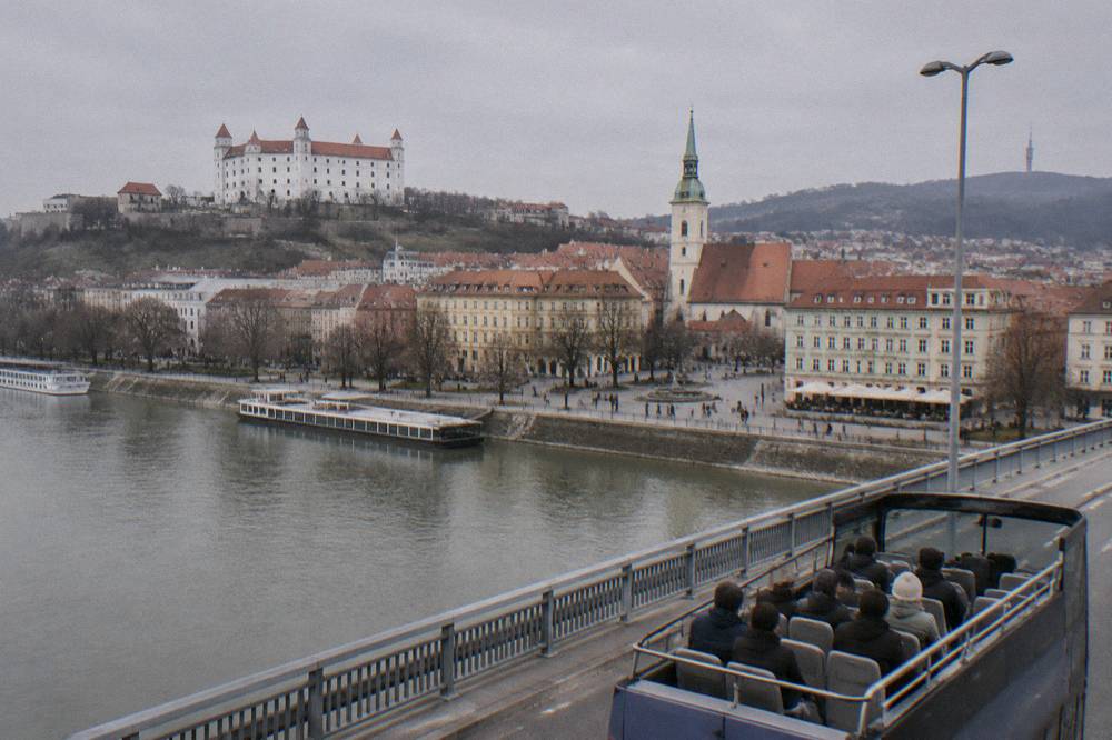 A sightseeing vehicle crossing a bridge over the Danube in Bratislava